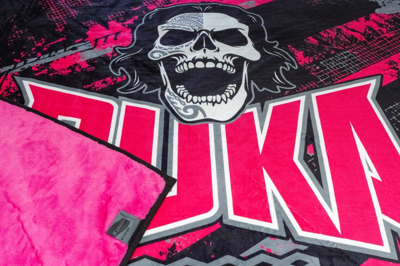 Close-up of a photo-realistic mascot print on a pink-backed Swanky NubaySoft blanket, showing the fine detail and the Spectator Sport tag