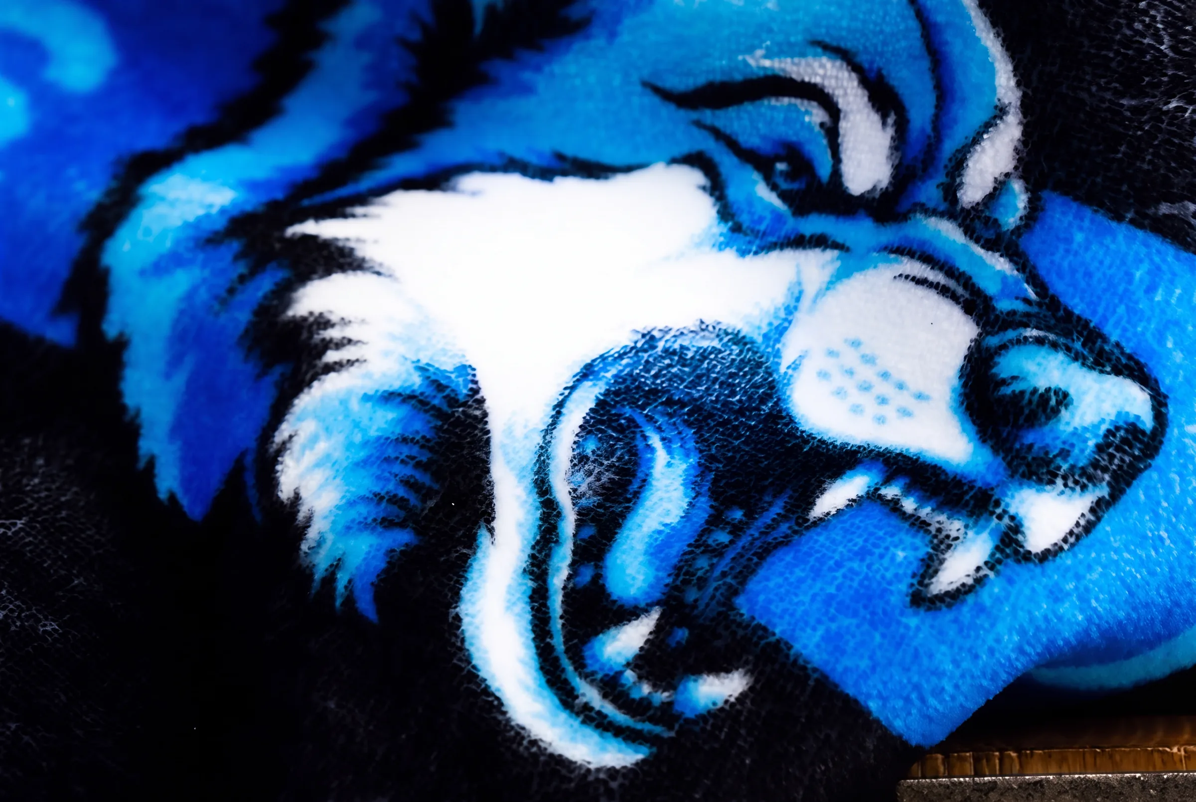 Extreme close-up of a wildcat mascot printed on plush NubaySoft fabric, showing individual fiber-level detail